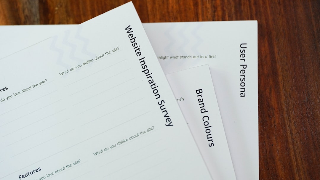 a-close-up-of-a-stack-of-papers-on-a-table-pagveo86up8